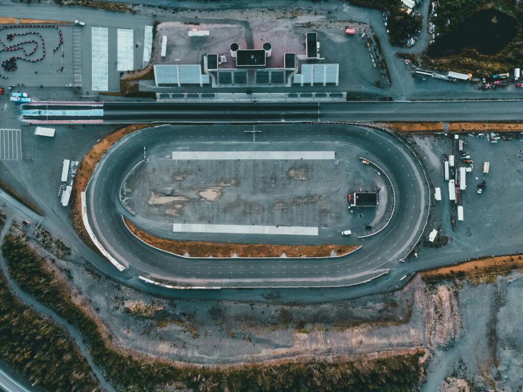 Aerial shot of an empty race track showcasing the circuit and surrounding area.